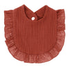 A rust-colored, ribbed cotton baby bib in a bandana style with ruffled edges.