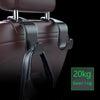 A close-up of a dark brown car seat headrest with black leather hooks and a green weight indicator labeled 20kg bearing.