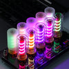 A collection of glowing LED night lights in frosted glass jars displayed on a dark surface.