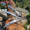 Three reciprocating saw blades are mounted on a tree trunk for display.