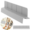 A gray flexible silicone sink splash guard with suction cups shown in various angles and context.