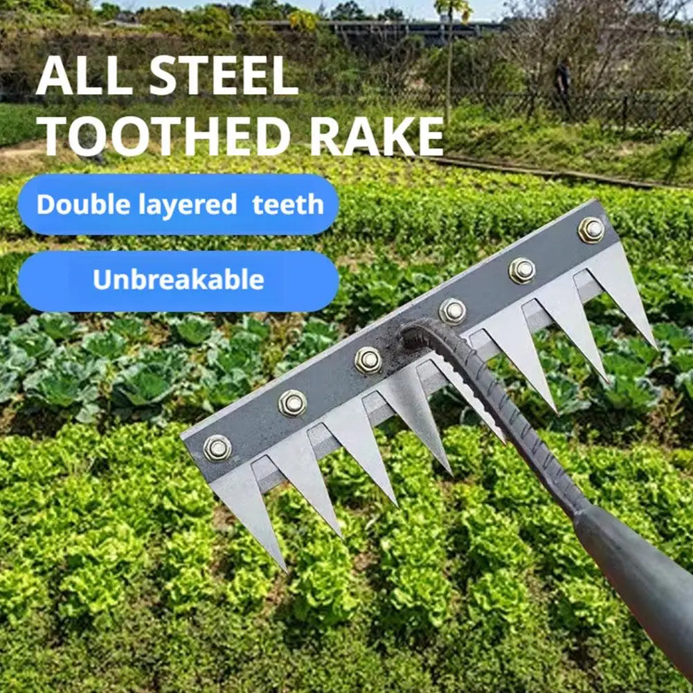 A close-up view of an all steel toothed rake with a double layered tooth design resting on green garden foliage.