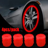 Four luminous red tire valve caps are shown next to a car wheel for sale.