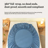 A rolled blue fitted bed sheet is displayed on a white bed, emphasizing its smooth and compliant fabric.