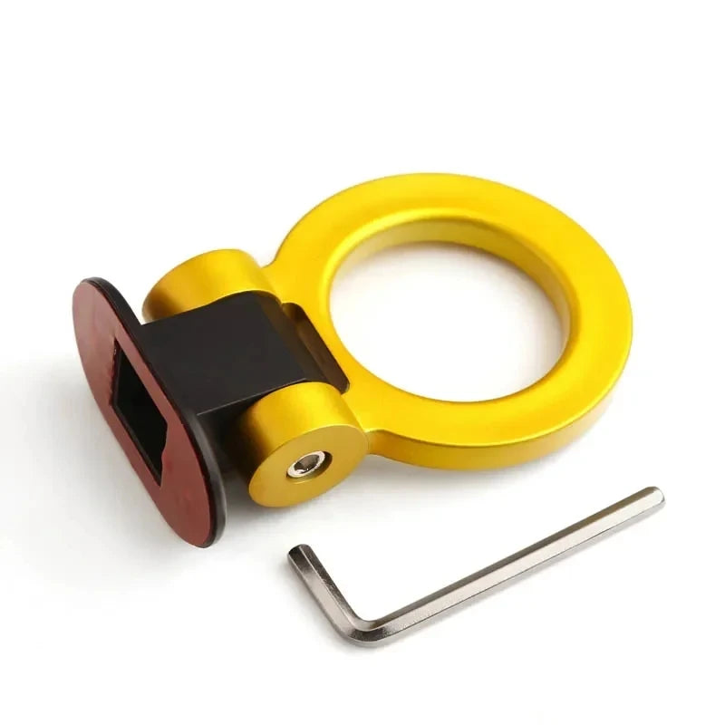 A gold-colored sporty trailer hook decorative accent for cars.