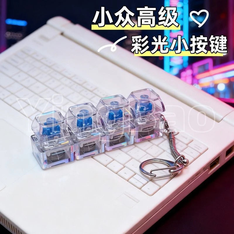 A set of clear LED macaron keyboard fidget toys are displayed on a white laptop keyboard.
