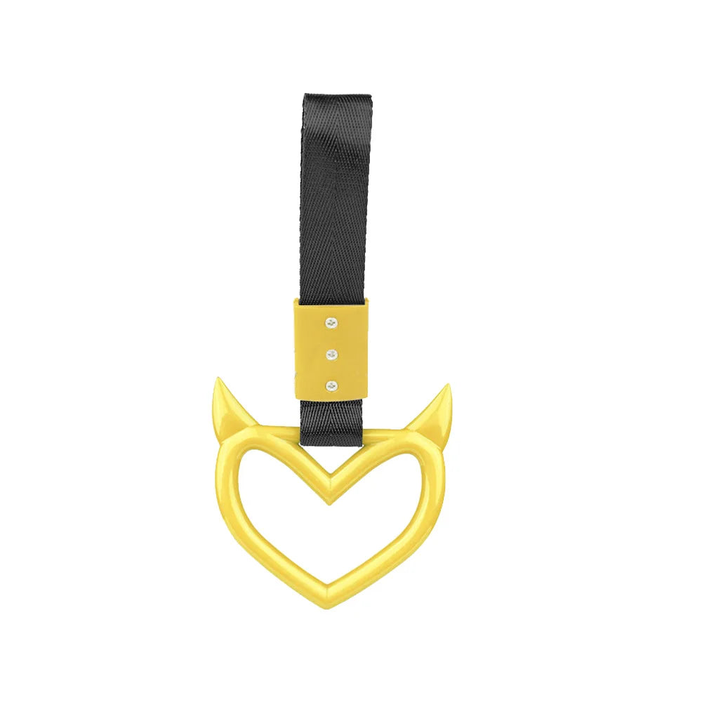 A gold heart-shaped ring with a black strap and yellow accents.