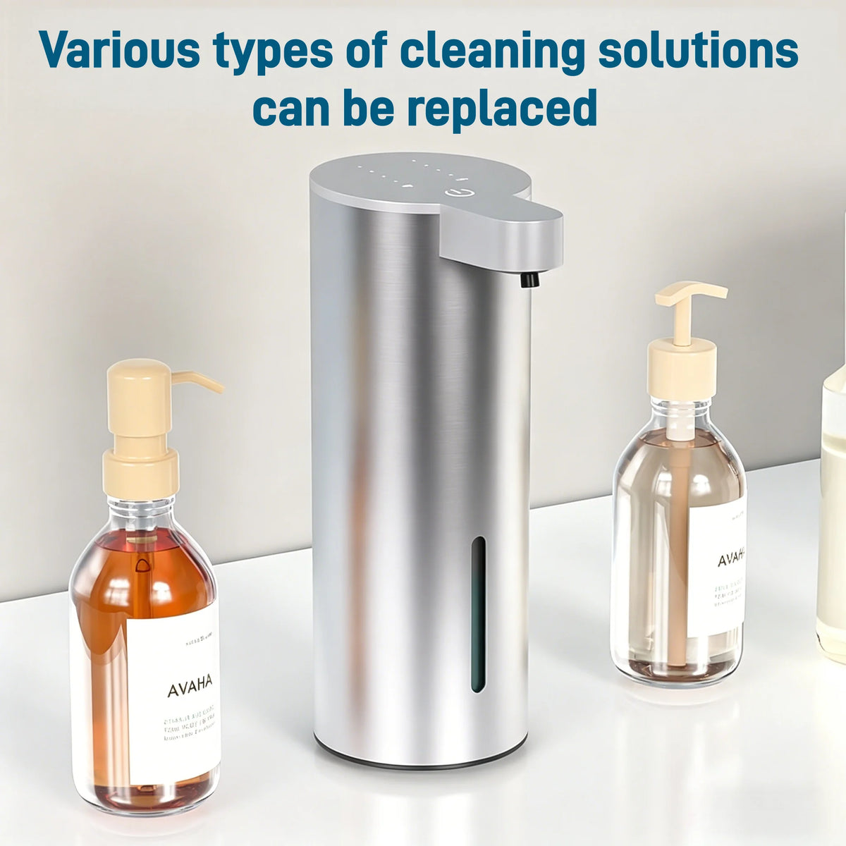 A stainless steel touchless automatic foam soap dispenser next to a glass bottle of liquid soap.