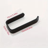 A black no-drill self-adhesive toilet paper holder with a strong wall mount shown against a white background.