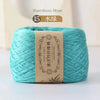 A ball of light turquoise bamboo fiber yarn labeled as Bamboo Fiber Cotton for knitting and crochet.