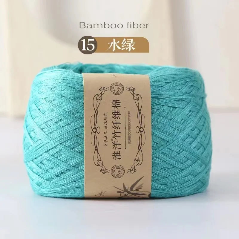 A ball of light turquoise bamboo fiber yarn labeled as Bamboo Fiber Cotton for knitting and crochet.