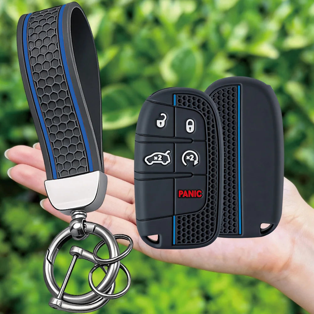 A hand holds a black silicone key fob cover with a silver chain attached, showing the textured grip and buttons.