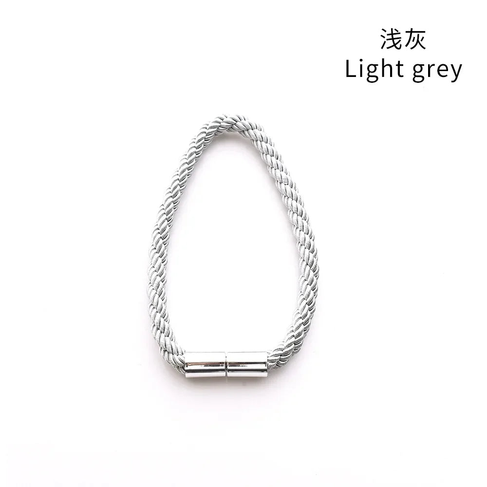 A silver light grey rope tieback with a magnetic clasp, shown against a white background.