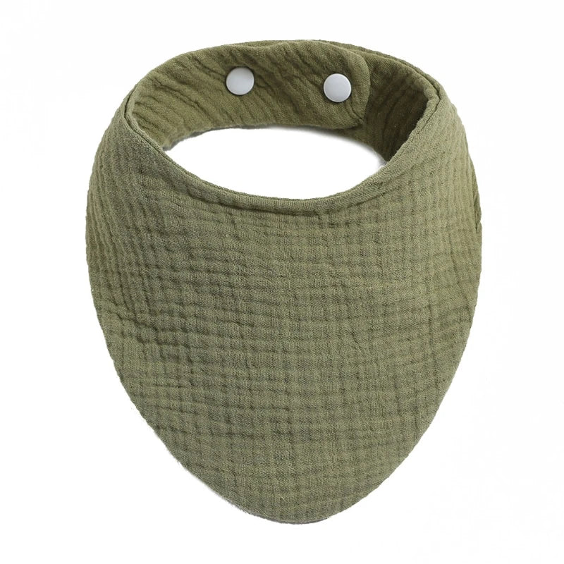 A round, olive green organic cotton muslin baby bib with a textured fabric and small white buttons.