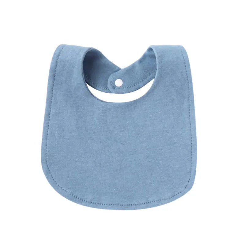 A light blue soft cotton baby bib with a cutout for the neck and a small button closure.