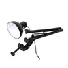 A black adjustable swing arm desk lamp with a spherical reflector and clamp mount.