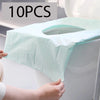 Ten pieces of light blue disposable toilet seat covers being placed on a white toilet bowl.