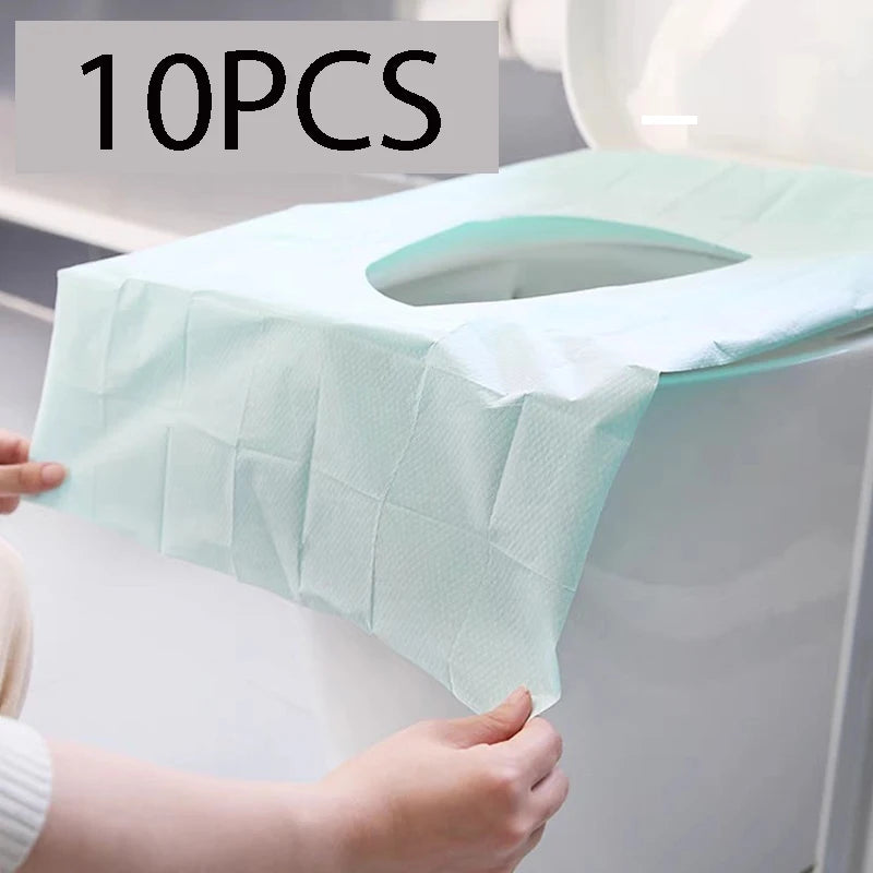 Ten pieces of light blue disposable toilet seat covers being placed on a white toilet bowl.