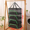 A folding hanging drying net with black mesh protection is displayed on a wooden rack.