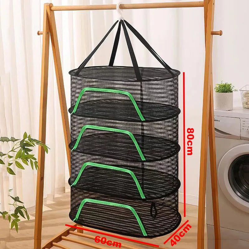 A folding hanging drying net with black mesh protection is displayed on a wooden rack.