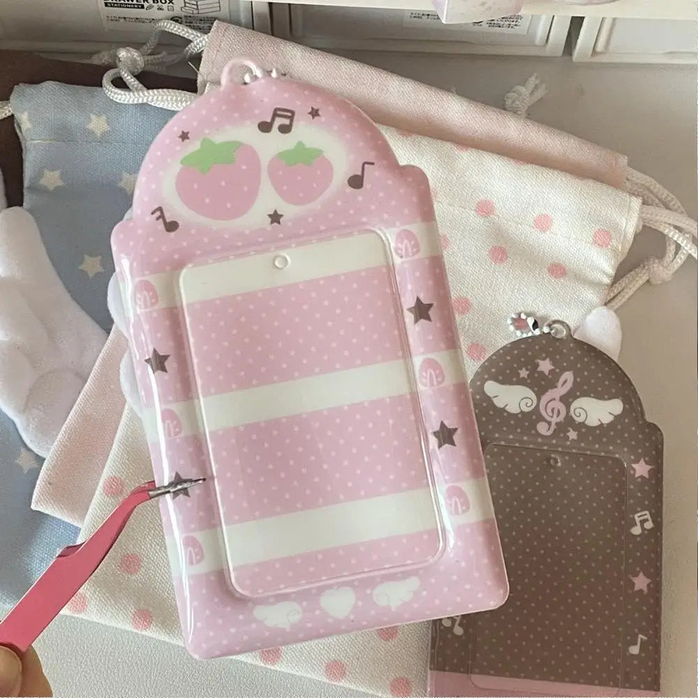 A pink strawberry card holder keychain with a clear plastic cover and decorative elements.