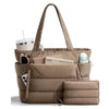 A tan quilted puffy tote bag with a laptop sleeve and a small zippered pouch.