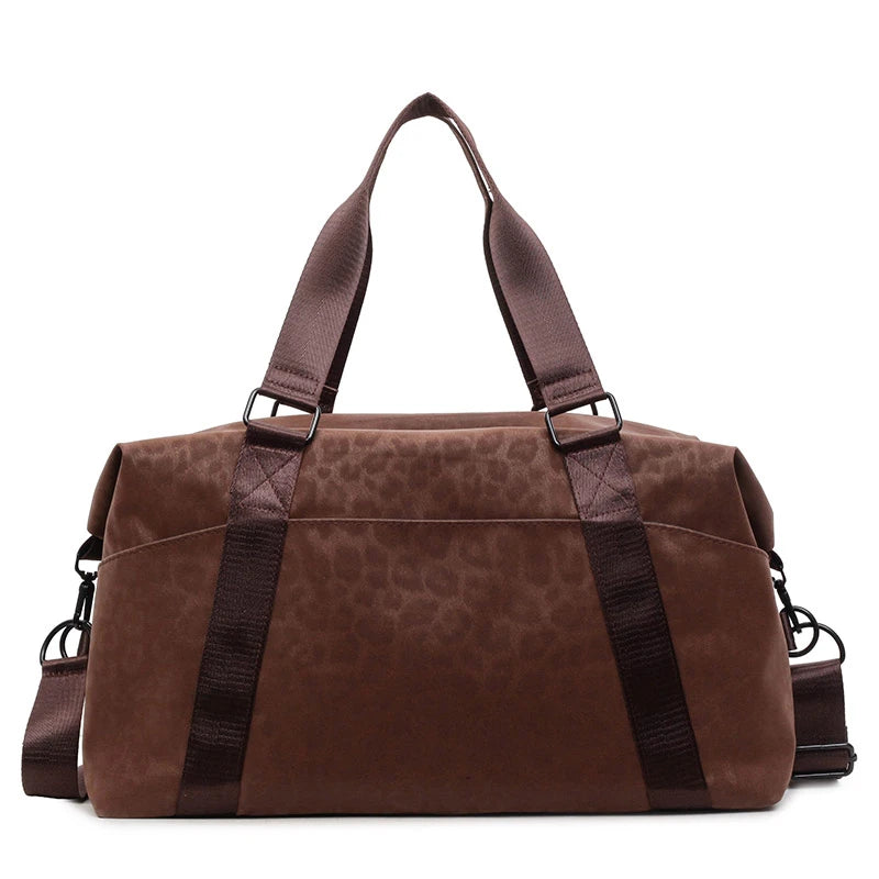 A brown leopard print duffle bag with adjustable straps shown from the front.