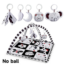 A baby play gym mat with various hanging toys including animal shapes and fabric pieces.