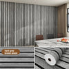 A close-up view of a dark gray wood grain grille wall sticker applied to a vertical surface.