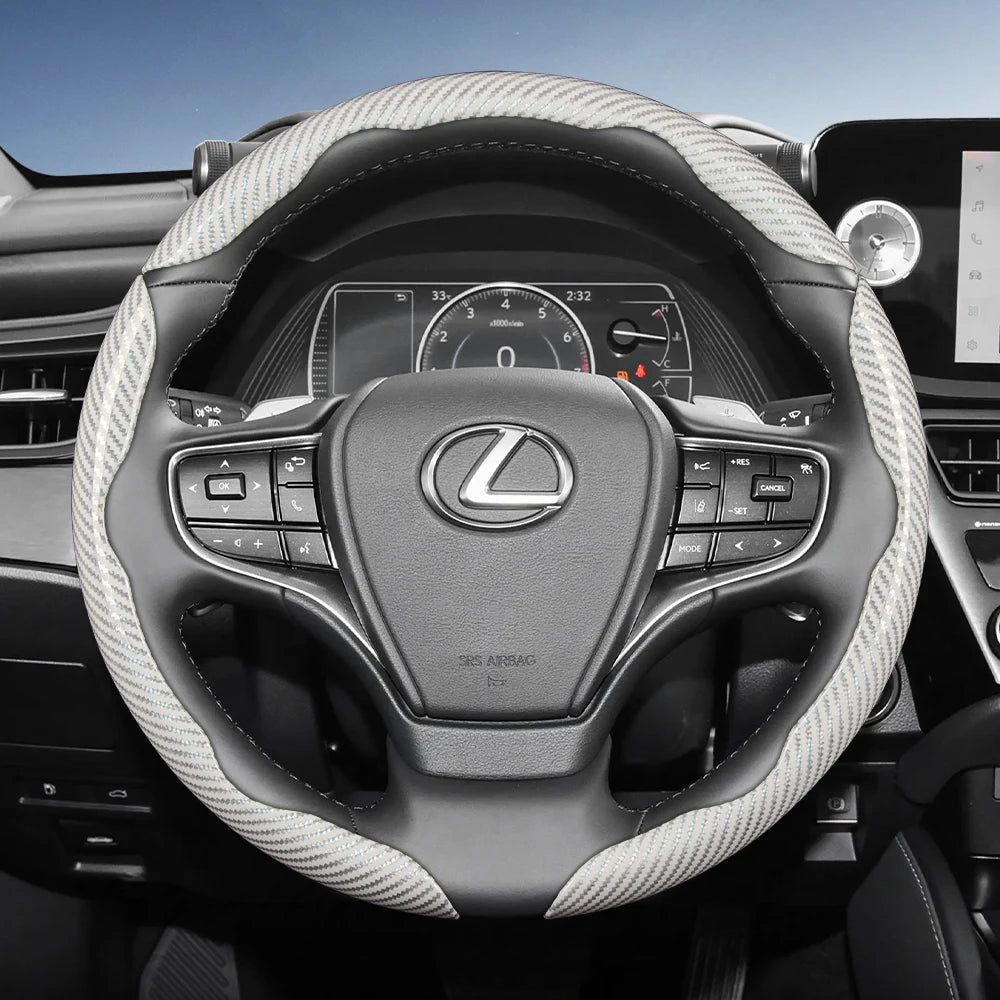 Interior view of a Lexus steering wheel with carbon fiber texture cover and controls.
