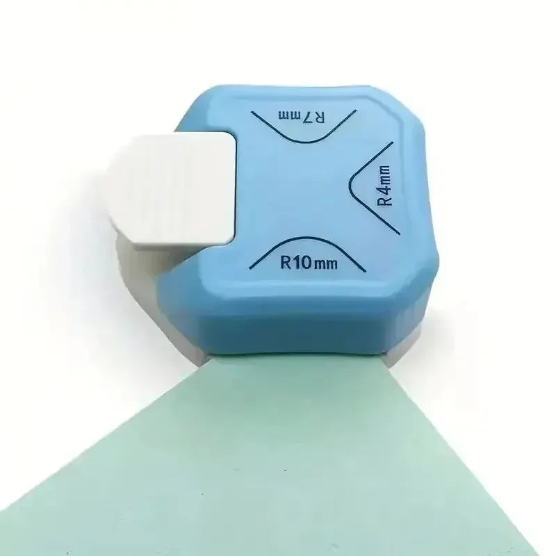 A light blue corner cutter tool with various roundness markings for photos, cards, and paper crafts.