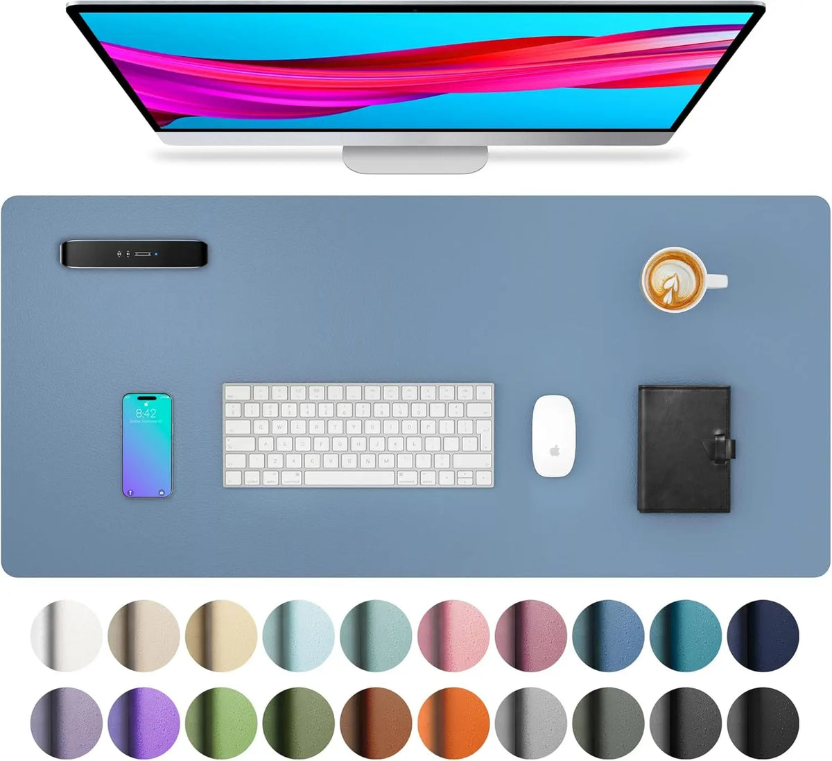 A computer monitor displaying a vibrant pink and red gradient, surrounded by a blue desk pad, a smartphone, keyboard, mouse, 