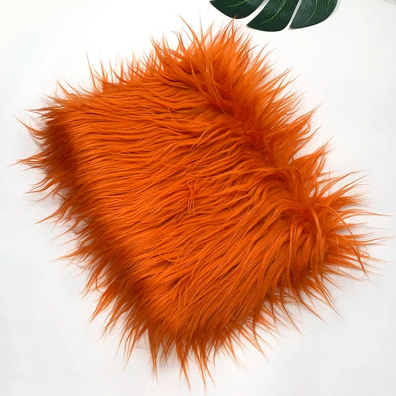 A fluffy orange faux fur fabric used for DIY sewing, doll hair, and cosplay.