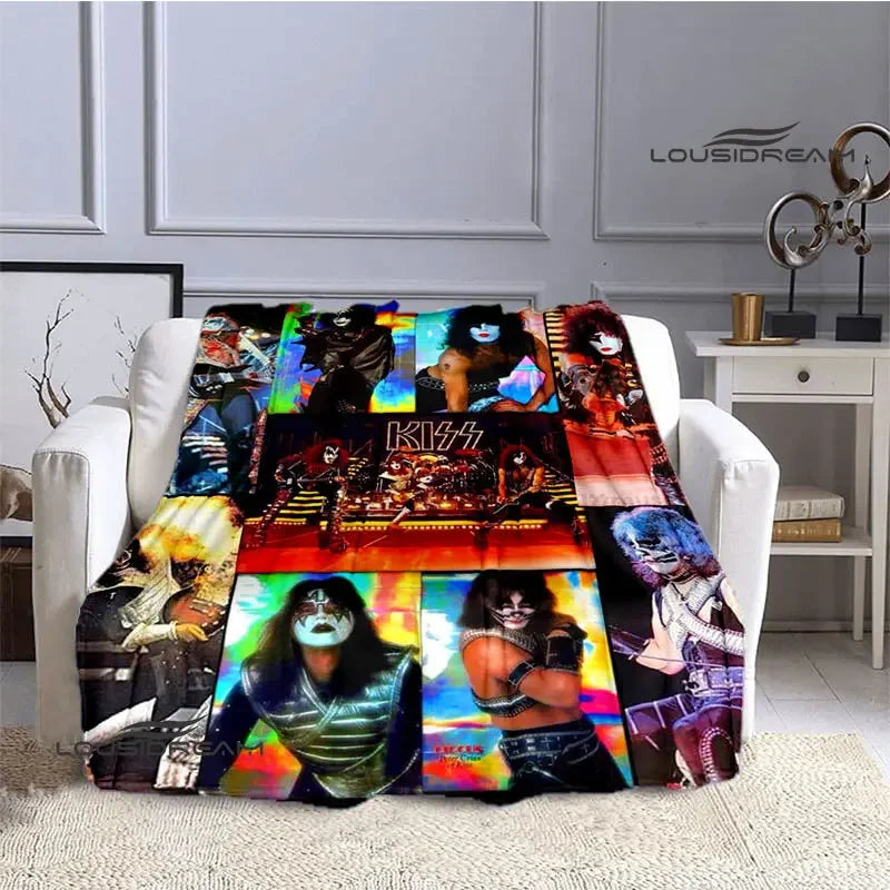 A flannel throw blanket featuring various designs and imagery of the Kiss band members.