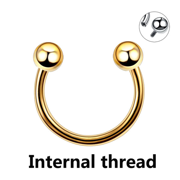 A close-up view of a polished gold-toned internal thread horseshoe septum ring.