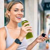 A woman holds a green juice bottle with a tamper-evident cap, smiling while looking at the camera.