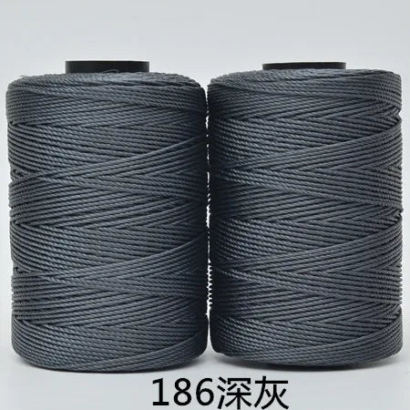 Two spools of dark gray 3-ply polyester knitting yarn for crochet and hand crafts