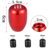 Red aluminum gear shift knob with adapters and various sized threaded adapters shown alongside.