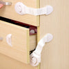 A close-up of a light wood cabinet drawer with white safety locks installed on the front and side.