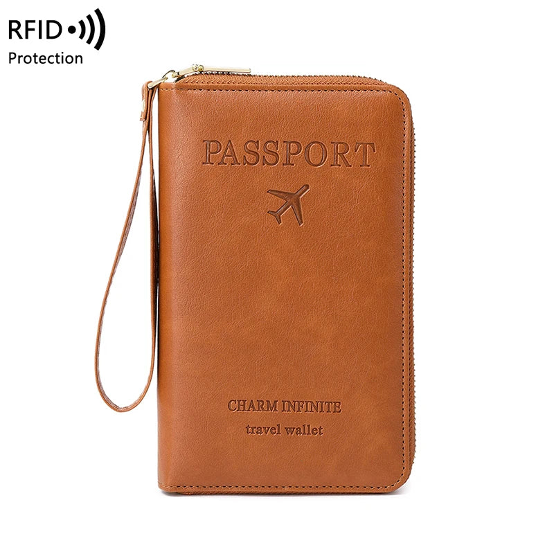 A brown leather passport wallet with a wrist strap and an airline symbol embossed on the cover.