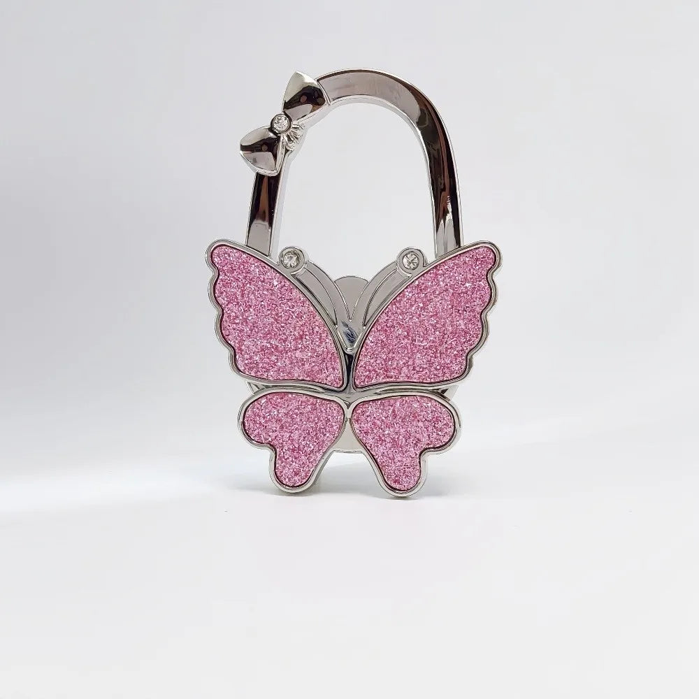 Silver foldable butterfly shaped handbag hook with pink glitter finish