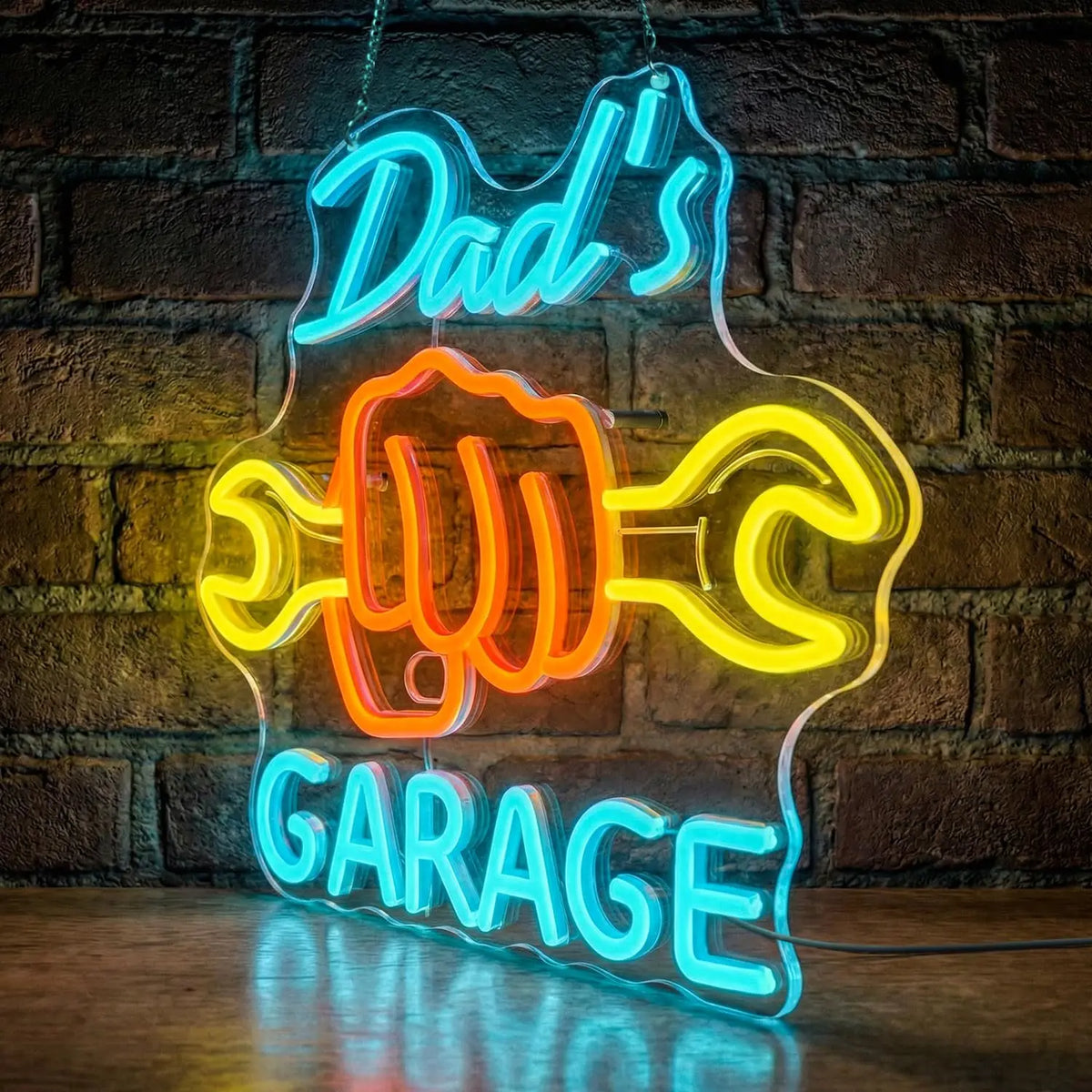 Blue and orange neon sign shaped like a fist with the words Dad's Garage glowing on a brick wall.