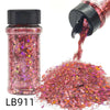 A glass jar of holographic chunky nail glitter mix with a black shaker top next to a pile of the same pink glitter.