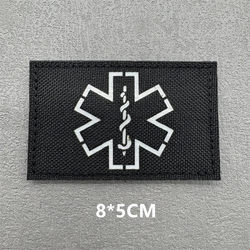 Black fabric patch featuring a white medical cross symbol with an IV drip design.