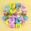 A collection of colorful, squishy face-changing stress relief toys with various expressions and colors.