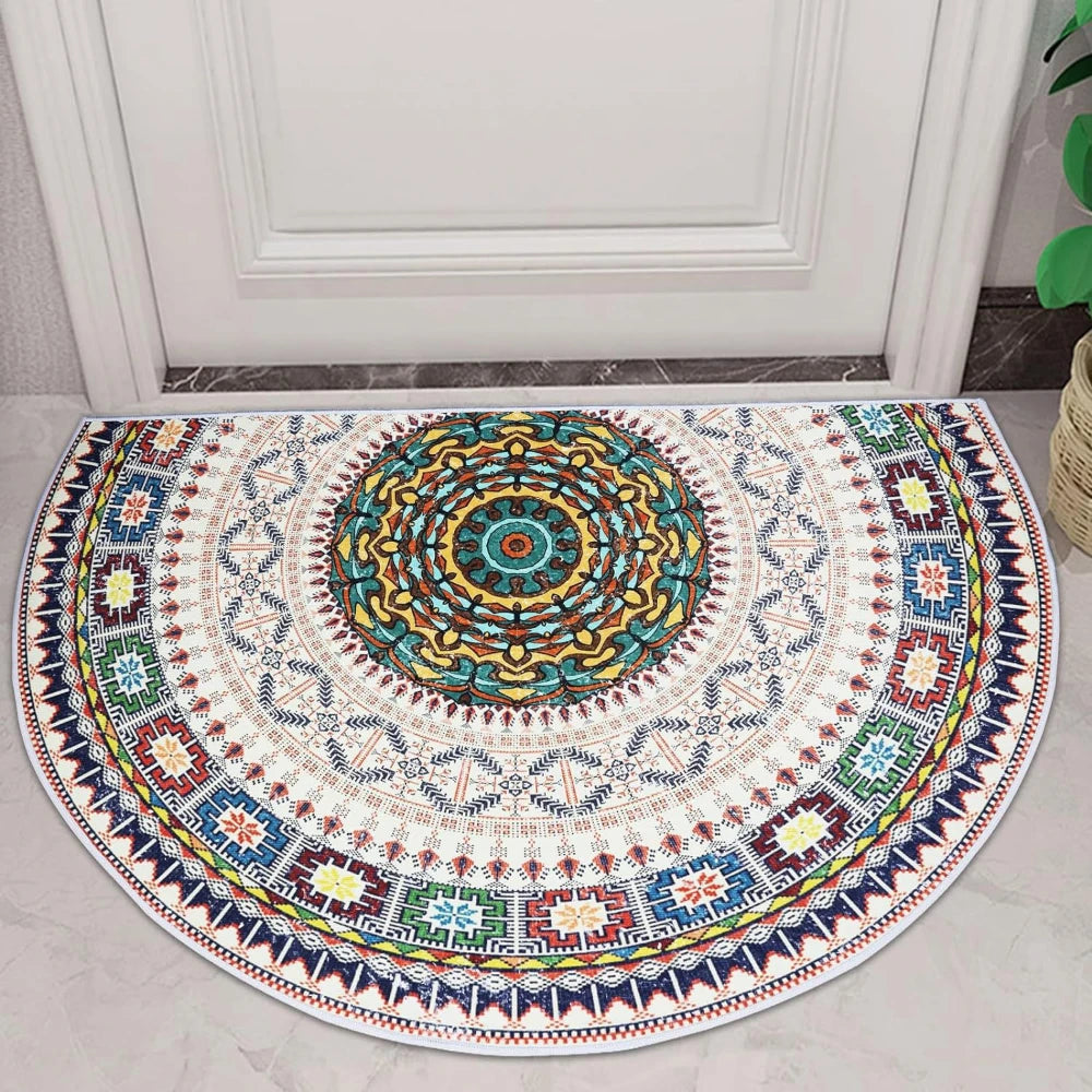 A semi-circle doormat featuring a colorful, intricate tribal boho pattern with geometric designs in blues, yellows, and earth