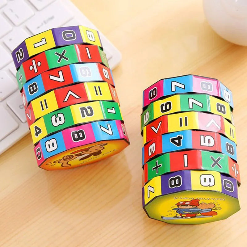 A stack of colorful Montessori math cubes showing numbers and arithmetic operations on a wooden surface.
