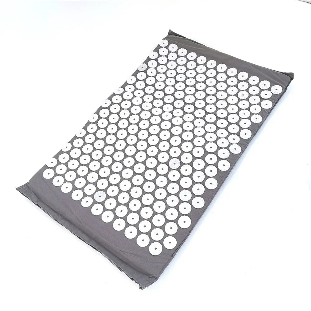 Gray acupressure mat with numerous white suction cup dots for pain relief and relaxation