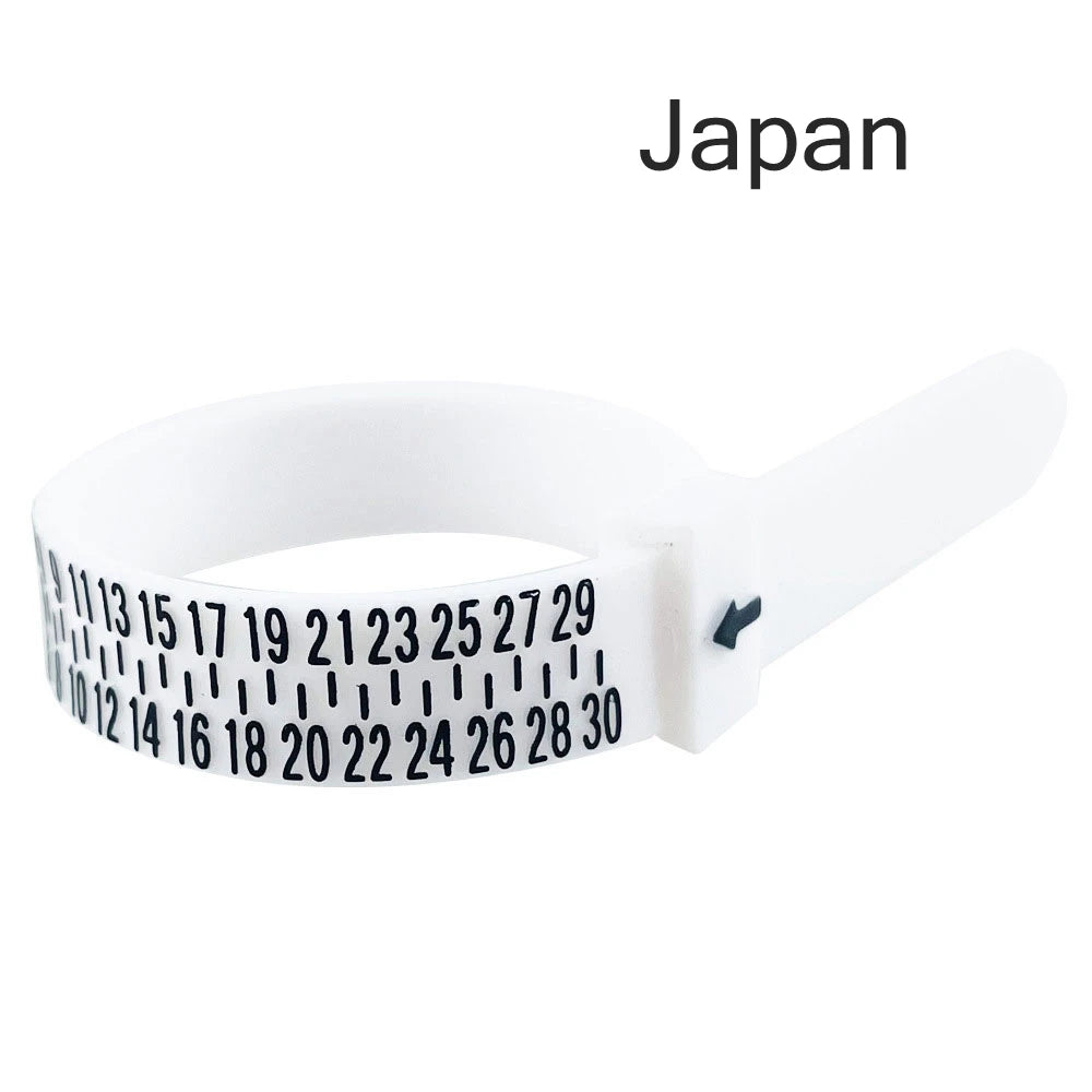 A white adjustable ring and bracelet sizer tool with numbered markings for measuring rings.