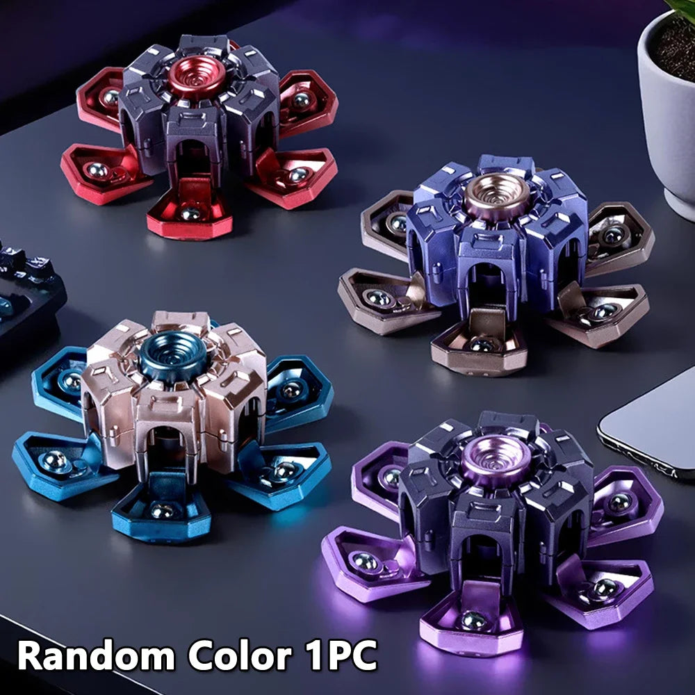 A collection of five random color fidget spinners shown on a dark surface.